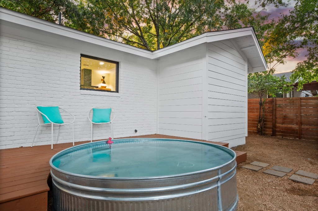 Home exterior view of backyard deck and pool angle 2.