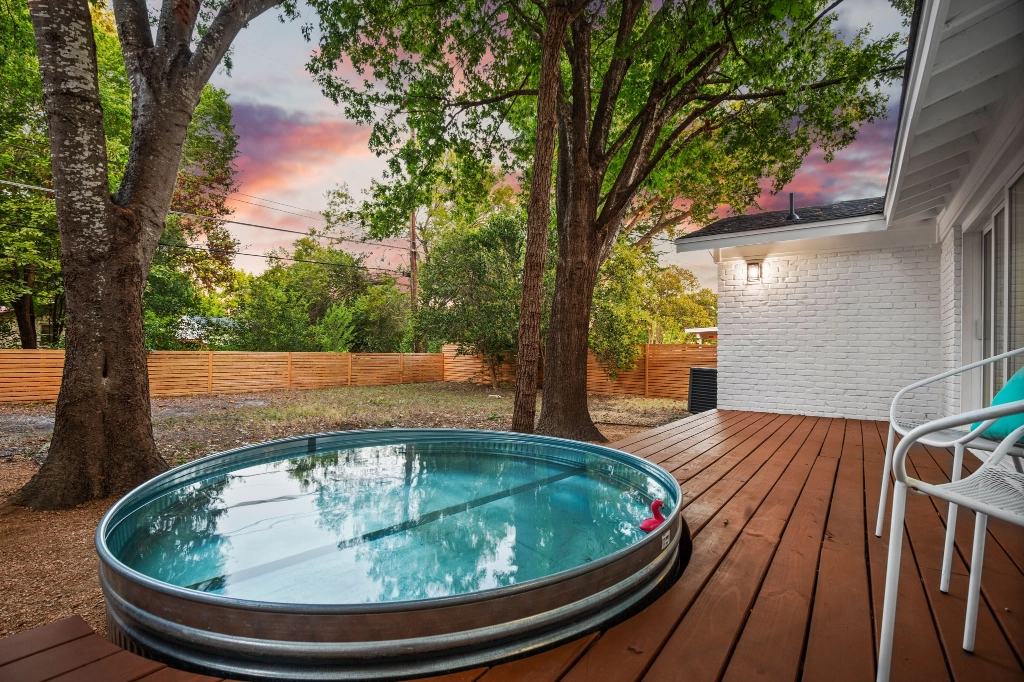 Home exterior view of backyard deck and pool angle 3.